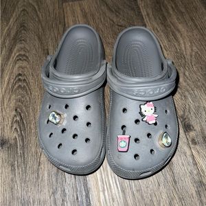 Grey crocs with charms